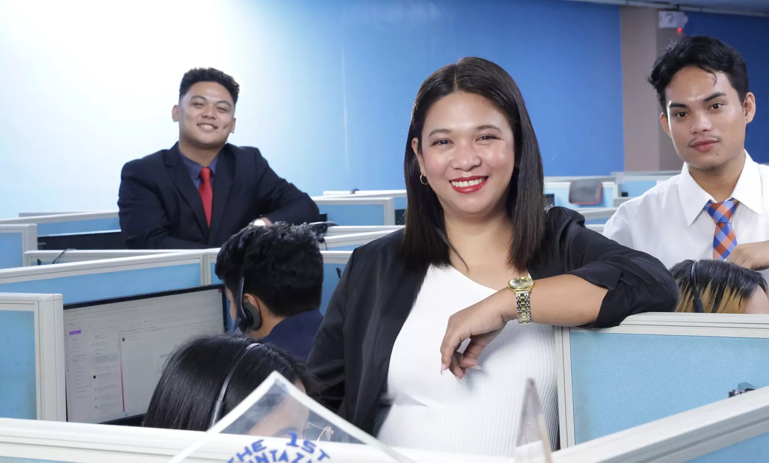 Operations team smiling at the camera in the workplace.